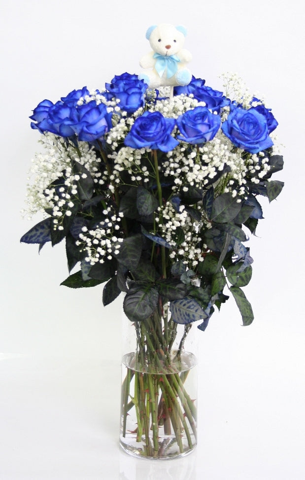 Blue roses bouquet with gypsophile and blue bear